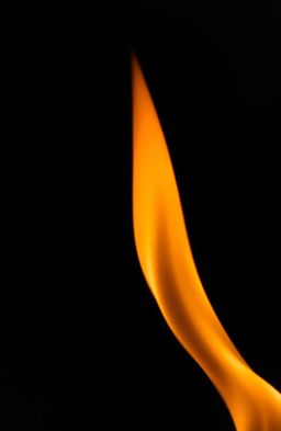 A delicate and fragile flame flickering gently against a dark background, casting soft shadows and a warm glow