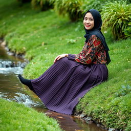 A girl dressed in a luxury hijab and a vividly patterned abaya is seated gracefully on the lush green grass beside a gentle water stream