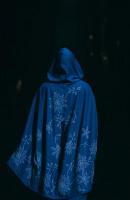 A woman wearing a beautiful blue cloak adorned with intricate white flowering patterns, her hood covering her head as she walks into a dark, mystical forest