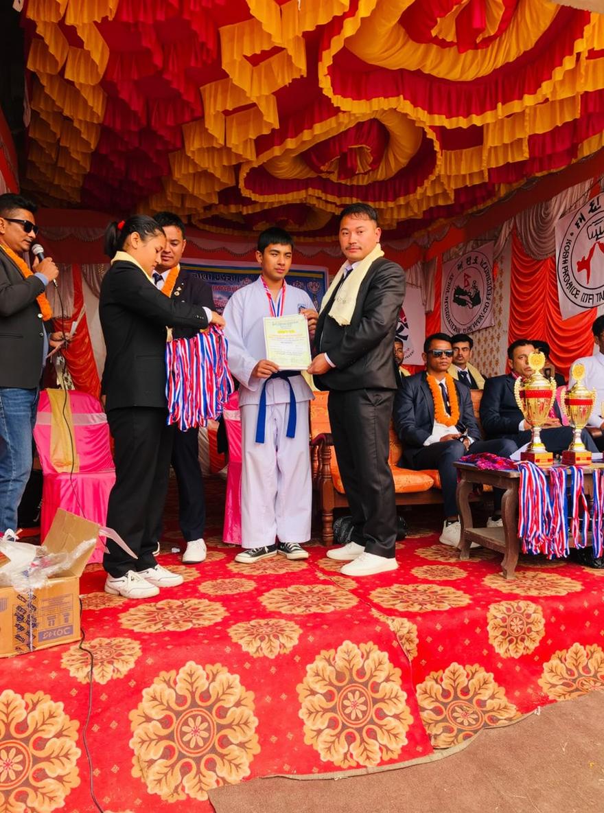 A vibrant awards ceremony scene with a decorated stage featuring colorful drapes and floral arrangements