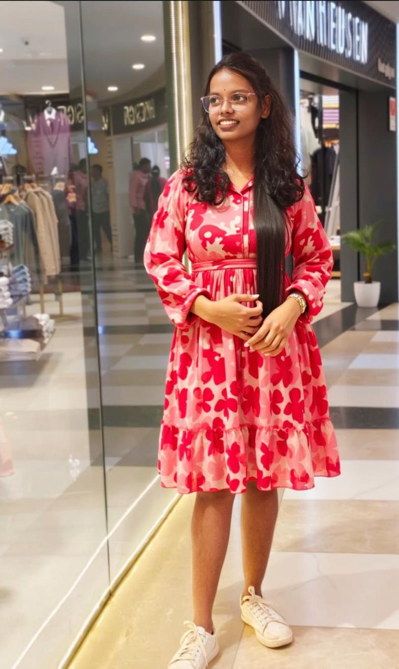 A young woman standing confidently in a bright and trendy shopping mall