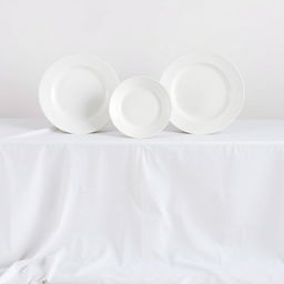 A composition featuring three identical white plates of the same size and shape made from different materials: one in pottery, one in china, and one in plastic