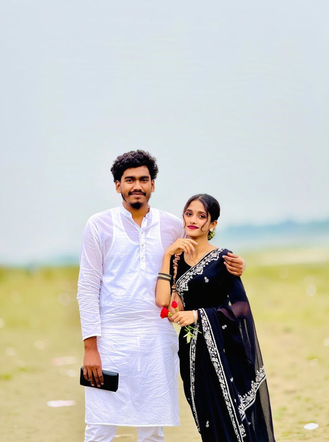 A young couple standing together on a beach