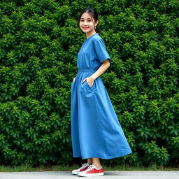 A beautiful Korean woman in a long blue retro summer style outfit, standing and facing the camera with a soft and cute smile, wearing sneakers