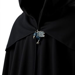 A magical black cloak featuring a tiny raven clasp at the front, intricately detailed and elegantly fastened, showcasing its enchanting fabric without any background