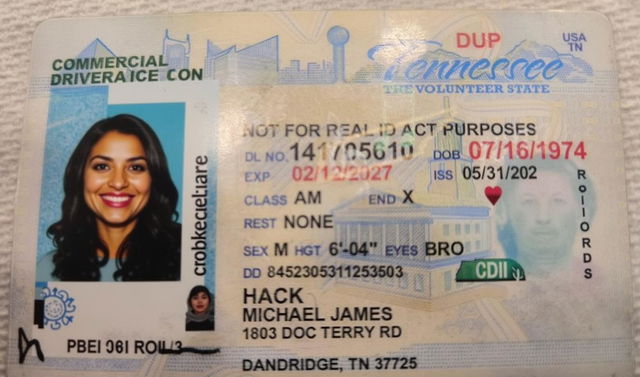 A freshly designed driver's license for the state of Tennessee, featuring a new photo of a well-groomed individual with a friendly smile, short brown hair, and brown eyes