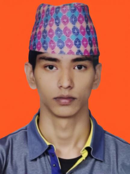 A portrait of a young man wearing a traditional Nepali topi, with colorful geometric patterns in pink and blue