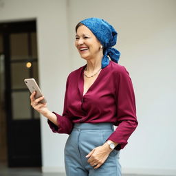 A middle-aged woman with a joyful expression, wearing a burgundy blouse and a patterned blue headscarf