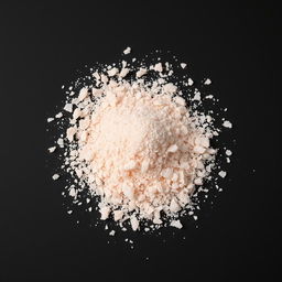 A heap of pink salt powder scattered on a surface, with no other objects in the image