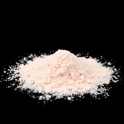 A pile of pink salt powder spilled on the ground, with no other objects present in the image