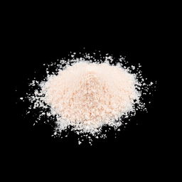 A pile of pink salt powder spilled on the ground, with no other objects present in the image