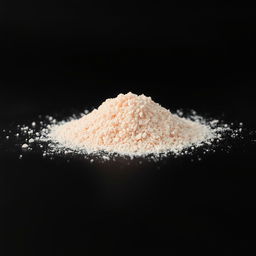 A mound of pink salt powder scattered on a surface, with a completely black background