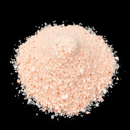 A heap of finely crushed pink salt powder with small crystalline grains, showcasing a beautiful blend of red, pink, and white hues