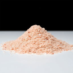 A mound of fine pink salt powder, consisting of tiny crystalline grains that are not individually visible, predominantly in shades of red with hints of pink and white, piled on a flat surface