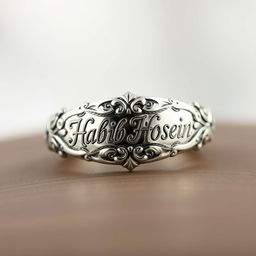 A beautifully crafted ring featuring intricate designs and the engraved name 'Habib Hosein' in elegant calligraphy