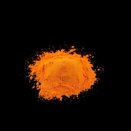 An image of a moderate amount of paprika powder spilled in a mound on the ground, without any other objects in the scene