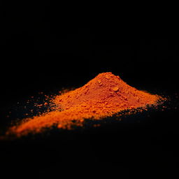 An image of a mound of paprika powder spilled on the ground, with no other objects present in the scene