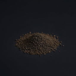 A mound of finely ground black pepper powder scattered on a plain, completely black background