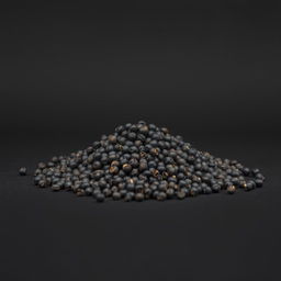 A mound of whole black peppercorns spilling on a flat surface, with no other objects in the image