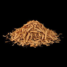 A mound of shredded cinnamon tree bark scattered on the ground, with no other objects in the image