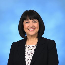 A professional portrait of a woman in her 50s, with short straight black hair that ends at her shoulders