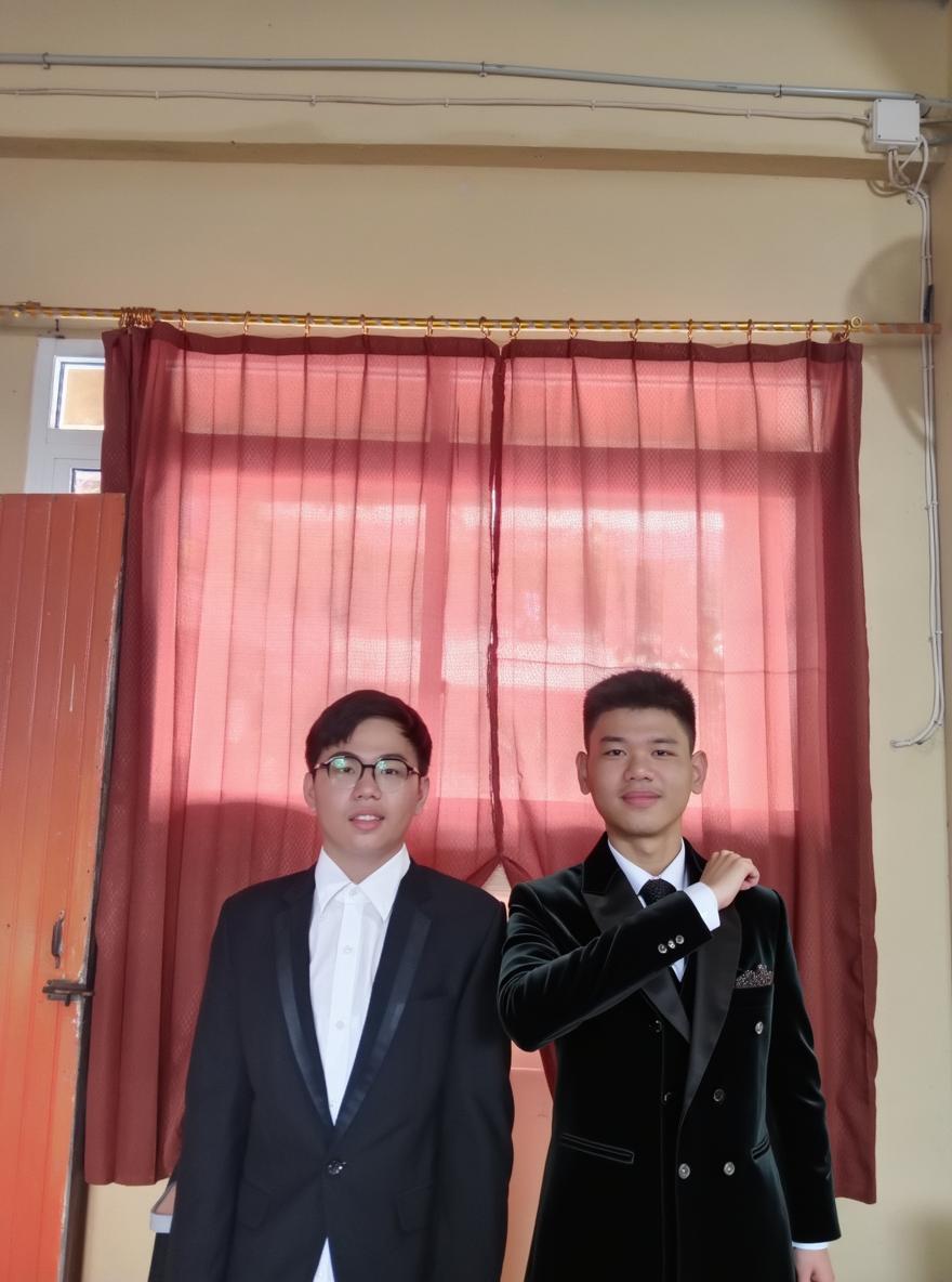 Two young men standing together in a room