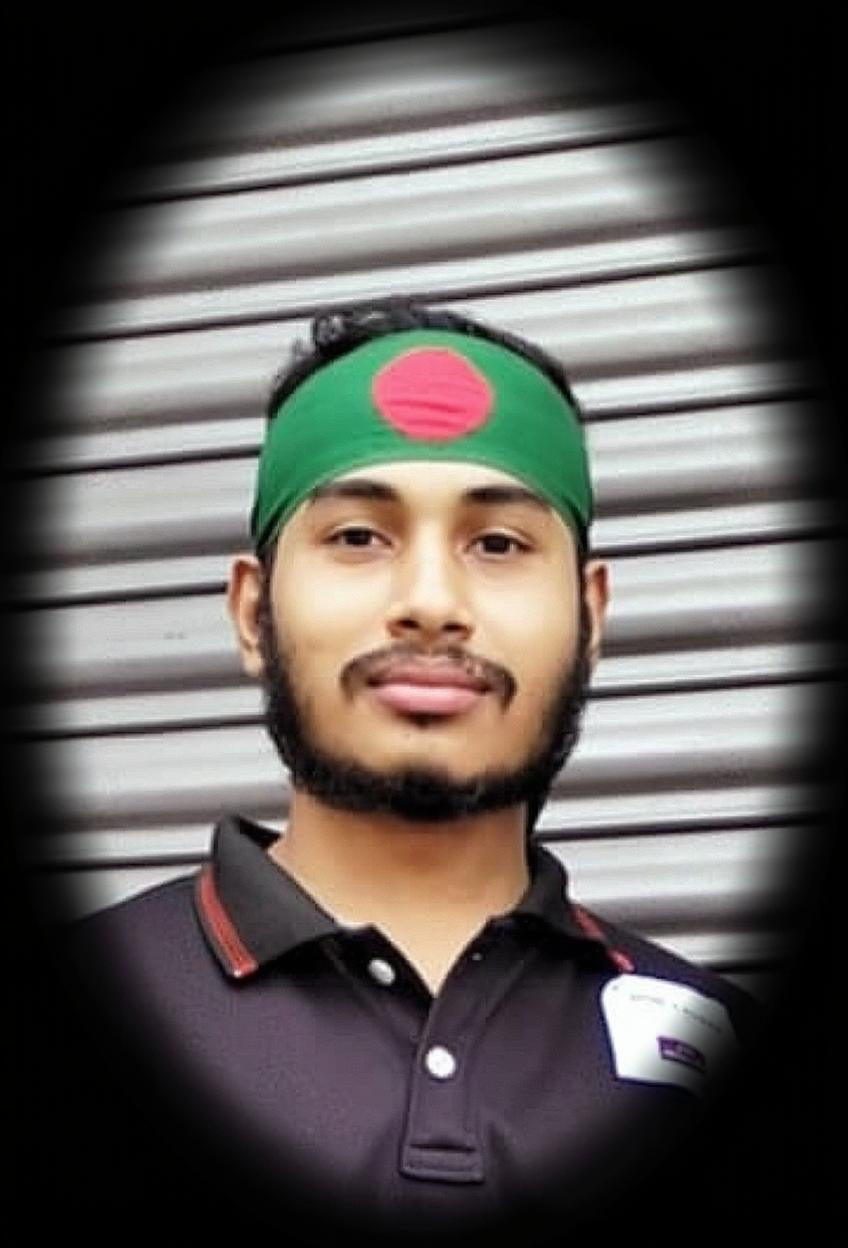A young man wearing a green headband with a red circle in the center, symbolizing Bangladesh's national colors