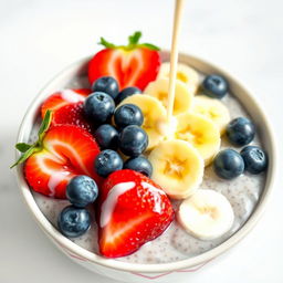 A delicious bowl of chia pudding topped with fresh strawberries, bananas, and blueberries, drizzled with creamy milk