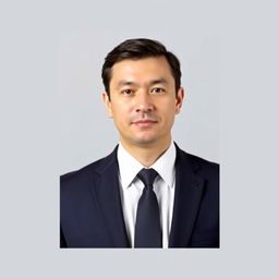 A professional passport-sized photo for a CV, featuring a straightforward portrait of an adult male with short dark hair, wearing a navy suit and a white dress shirt without a tie