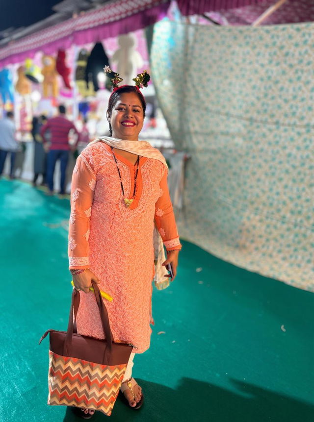 A vibrant festival scene featuring a joyful woman in traditional attire, standing against colorful decorations and festive stalls