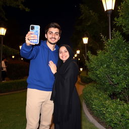 A romantic night scene in a park in Mashhad, featuring a young Iranian couple
