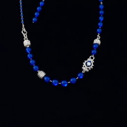 A stunning royal blue necklace elegantly displayed on a deep black background, showcasing intricate silver clasps and shimmering gemstones that reflect subtle light