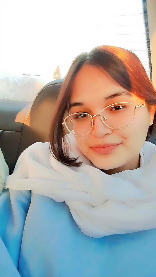 A portrait of a young woman sitting comfortably in a car during sunset, with adjusted color tones to enhance warmth and vibrancy