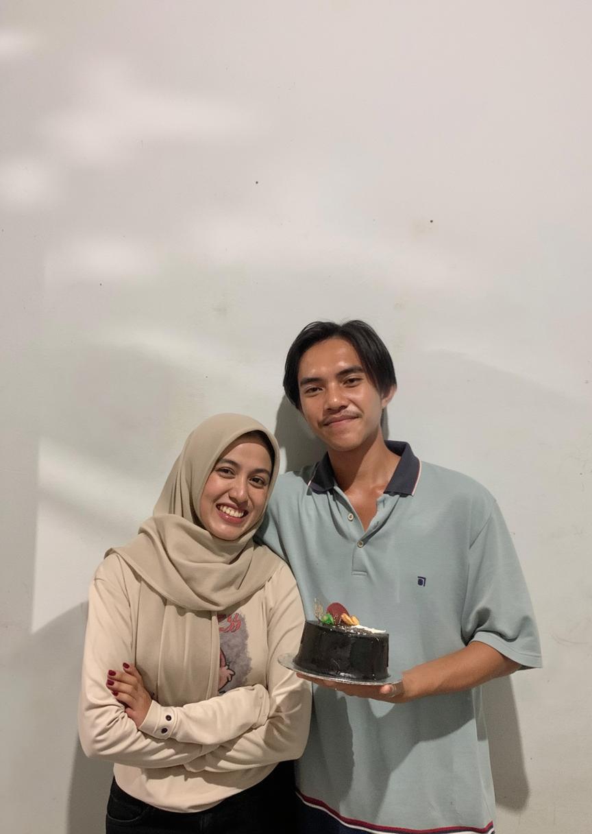 A joyful couple celebrating with a black forest cake