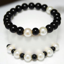 A stunning black bracelet adorned with luminous pearls, showcasing a luxurious design