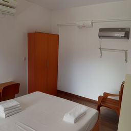 A cozy boarding house boasting free wifi, air conditioning, a wardrobe, study desk, bed, and an ensuite bathroom. Highlighting 24-hour security enforced with CCTV for optimum comfort and safety.