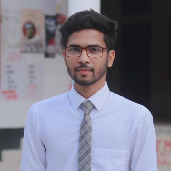 A young man standing confidently in a professional setting, wearing a crisp white dress shirt and a stylish grey tie