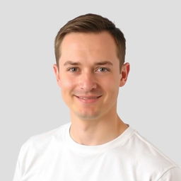 A professional headshot suitable for a resume, featuring a person wearing a clean, white t-shirt
