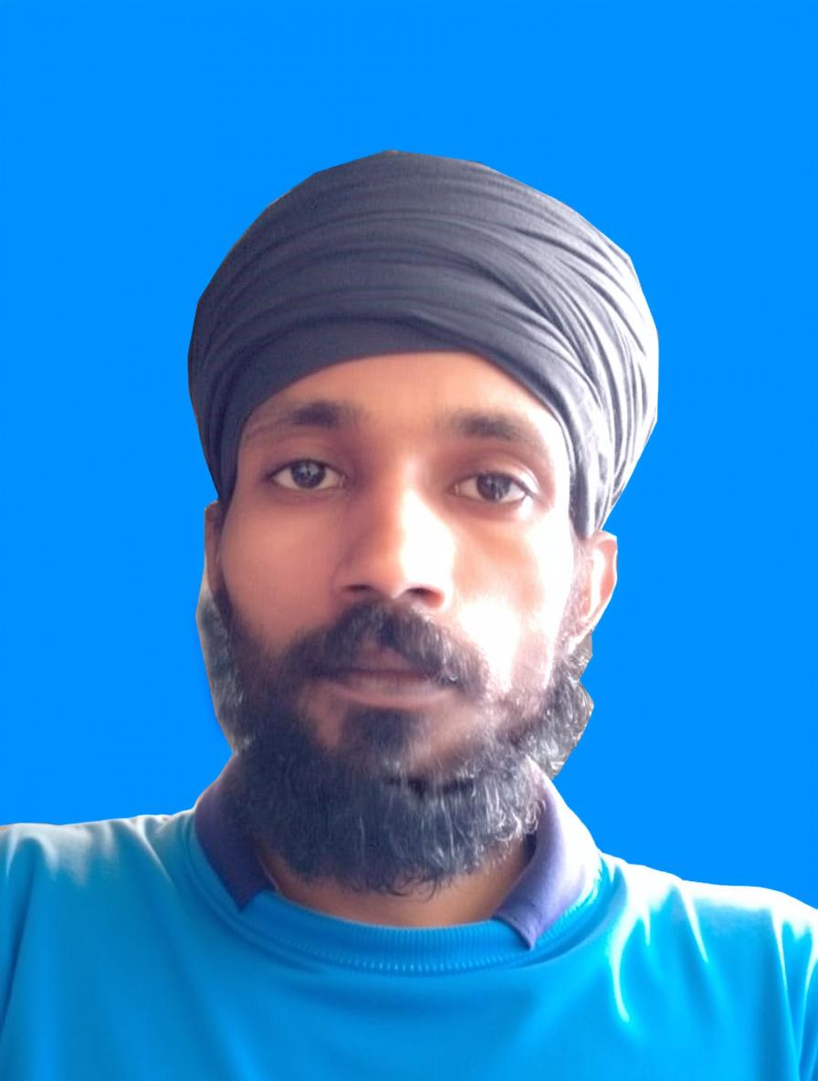 A man with a beard and turban, wearing a casual t-shirt