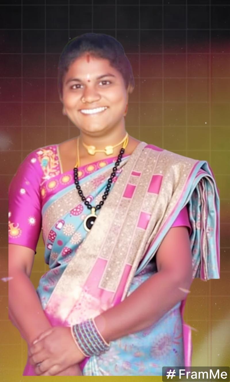 A woman wearing a vibrant traditional saree, smiling joyfully
