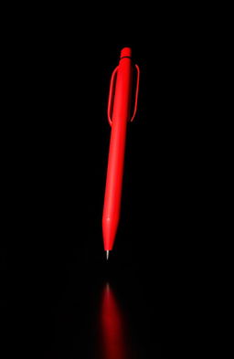 A dark background featuring a striking silhouette of a red pen, emphasizing its elegant shape and curves, casting a soft shadow on the surface beneath it, creating an artistic contrast between the bright red and the dark tones surrounding it
