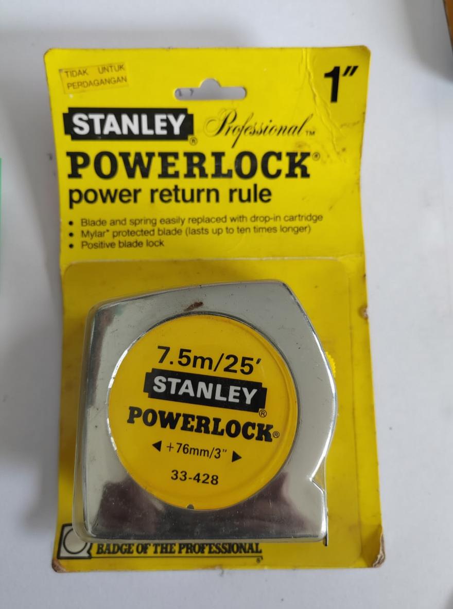 A high-quality product image featuring a Stanley PowerLock measuring tape prominently displayed