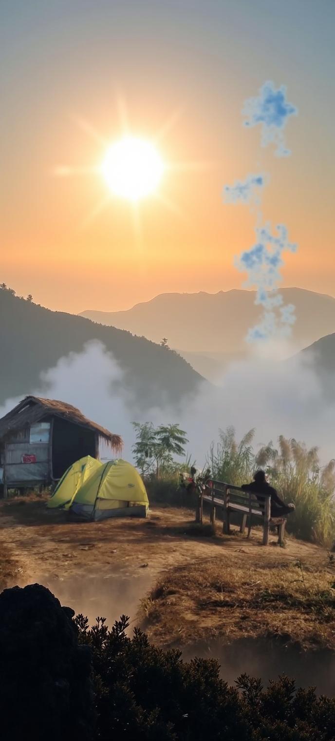 A serene camping scene at sunrise, featuring a yellow tent setup on a natural landscape
