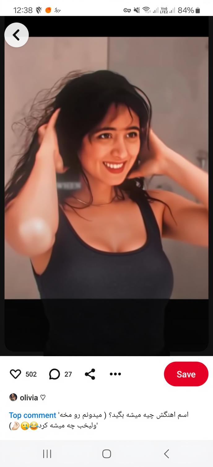 A confident young woman smiling warmly, standing in a stylish, modern bathroom setting with soft, ambient lighting