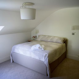 A comfortable 11 foot by 11 foot bedroom featuring a plush double bed.