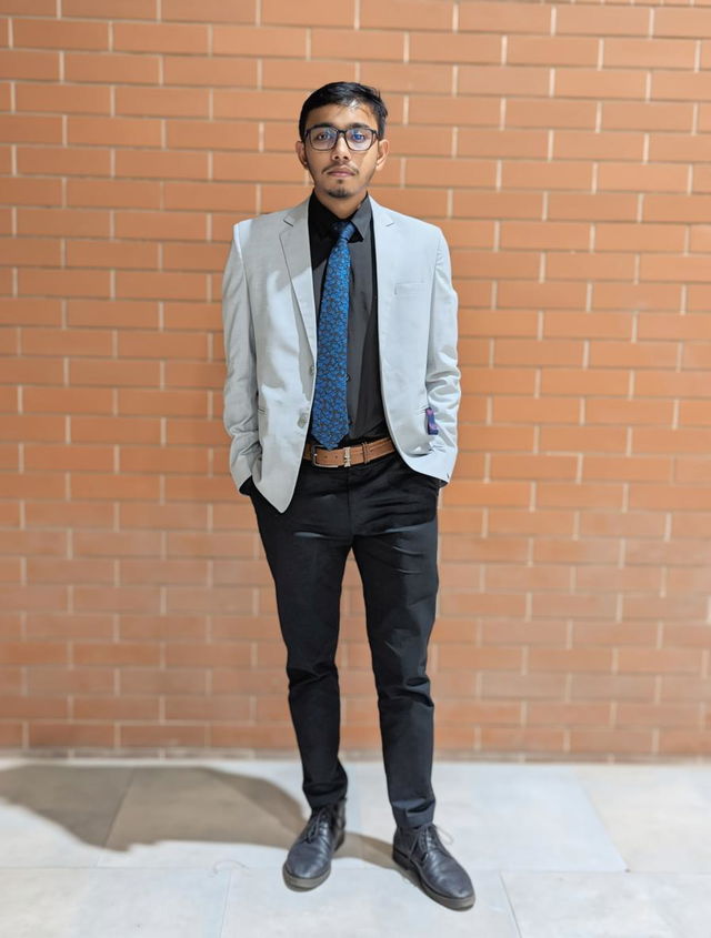 A young man standing confidently in a modern urban setting