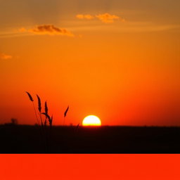 A photo featuring a vibrant sunset over a serene landscape, with the sun halfway dipped below the horizon casting warm golden and orange hues across the sky