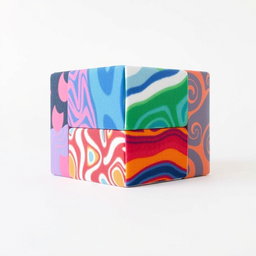 A detailed and colorful foam cube model with six sides, each side featuring a different vibrant pattern or design