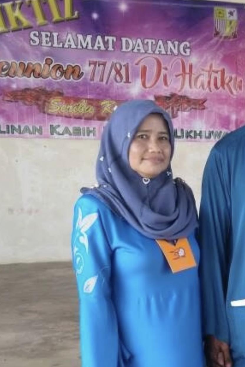 A woman with a confident smile, dressed in a beautiful blue outfit with elegant embroidery