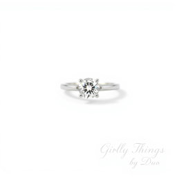 A stunning solitaire diamond ring placed against a clean white background, minimalist and chic design